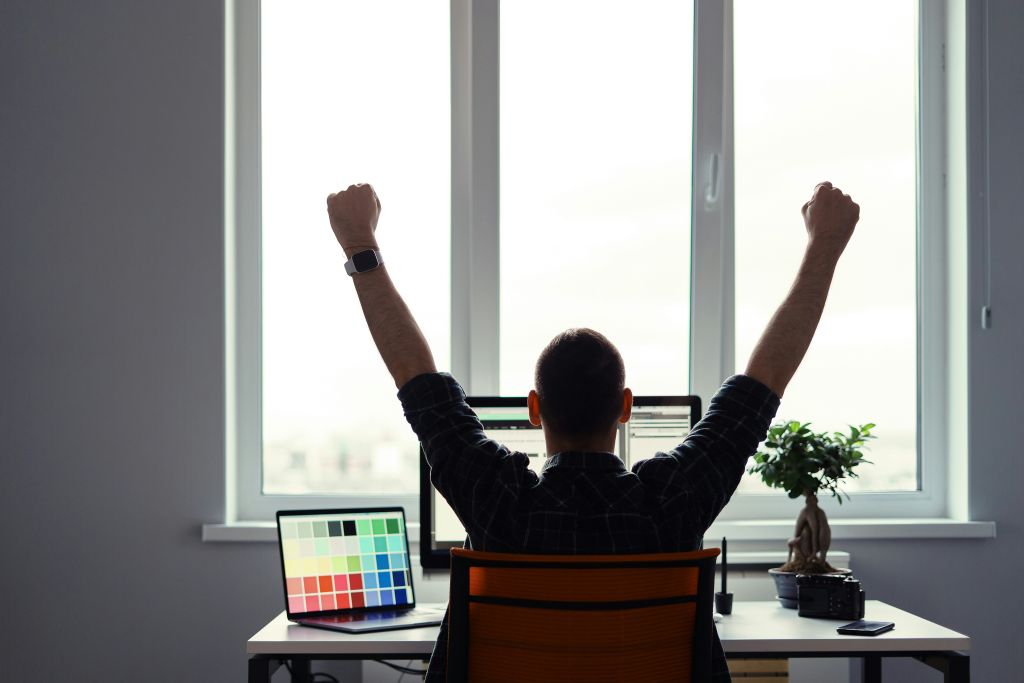 Man celebrating the success of his crowdfunding travel campaign