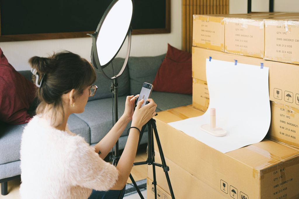 A person shooting products to sell and fund a travel