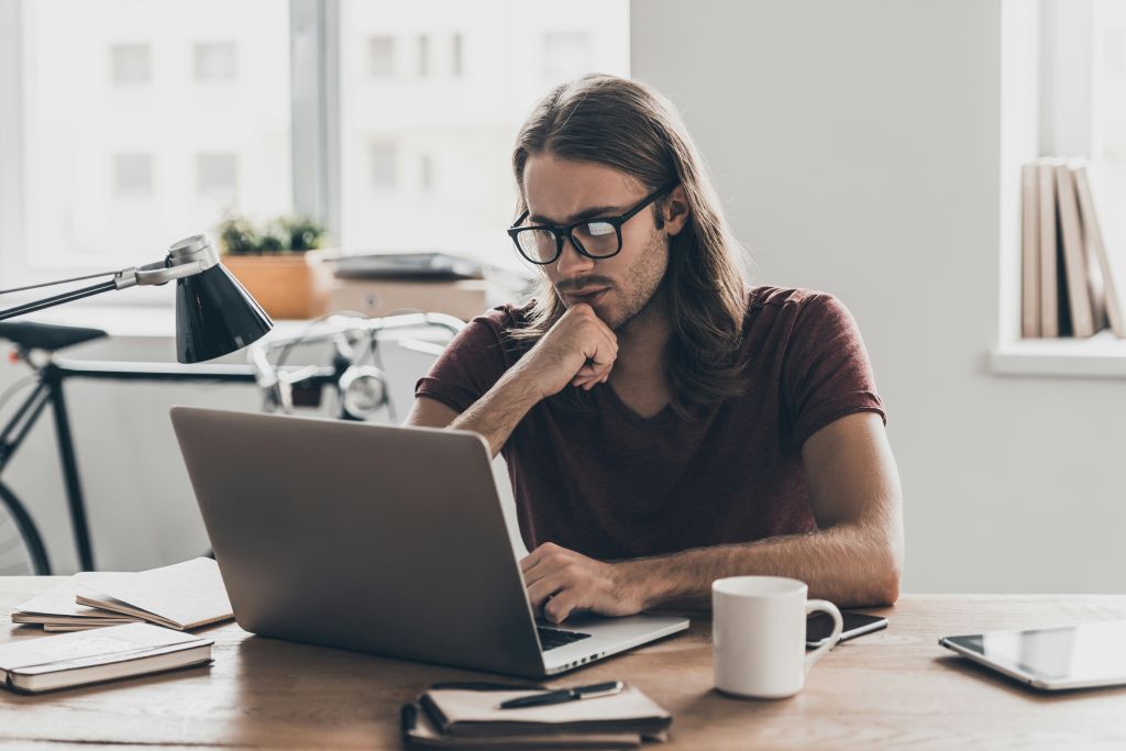 Fundraiser reviewing campaign details on laptop during mid-campaign phase