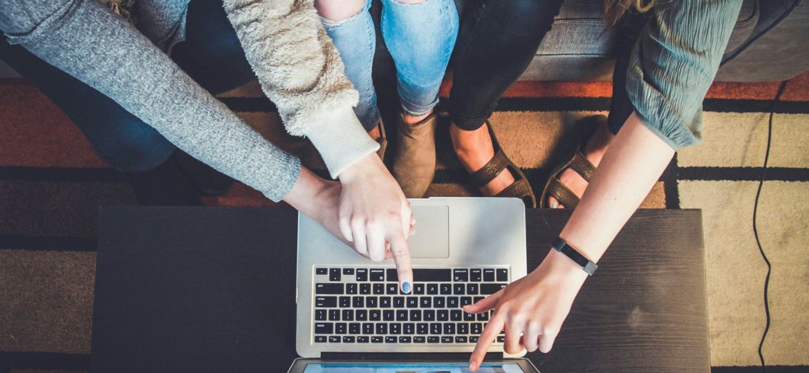 Group of friends choosing the right fundraising platform for travel.