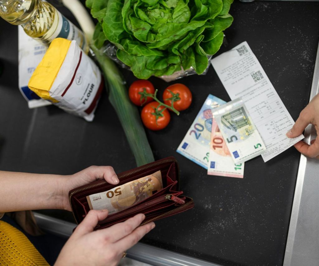 Paying for groceries at a checkout counter