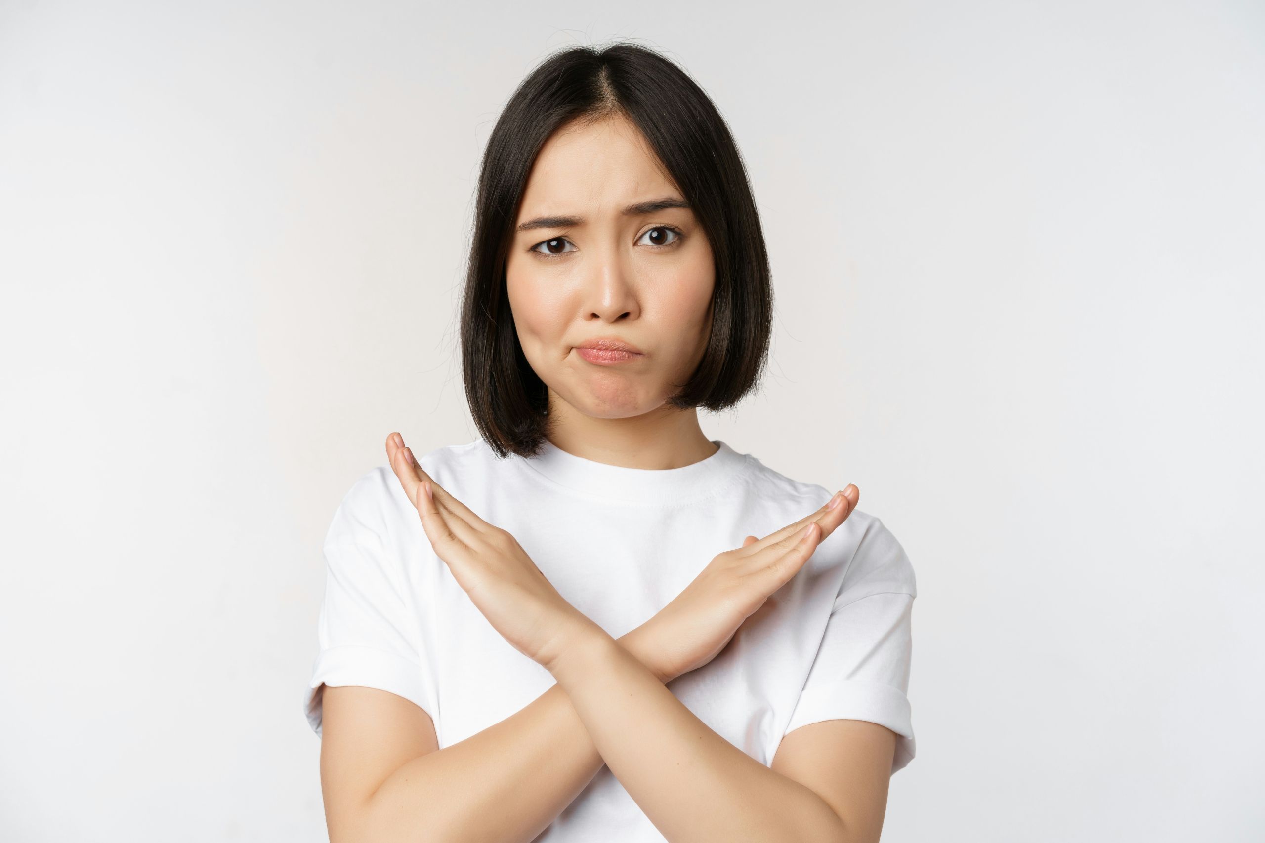 a woman with her hands folded over her chest