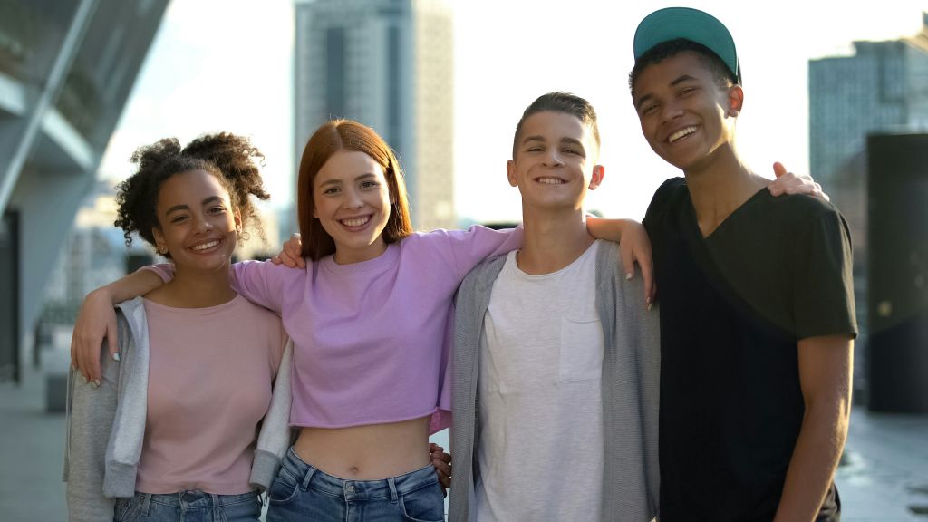 Four friends smiling together.